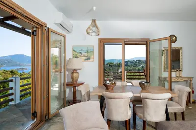 a dining room with a table and chairs at Villa Beis in Porto Rafti
