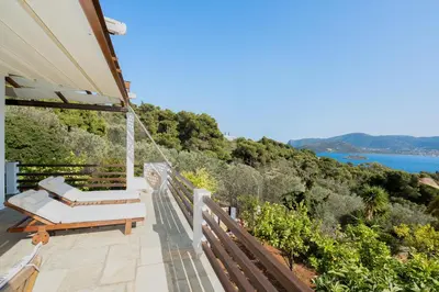 a balcony with a swing and a view of the water at Villa Beis in Porto Rafti
