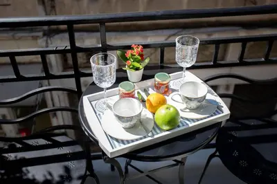 a table with a tray of fruit and wine glasses at Pandrosos Divine Suites in Athens
