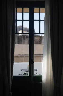 a view of a window with a table in front of it at Pandrosos Divine Suites in Athens
