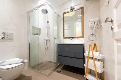 a bathroom with a glass shower and a toilet at Asty Luxury Apartments in Athens