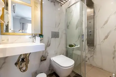 a bathroom with a toilet sink and a shower at Asty Luxury Apartments in Athens