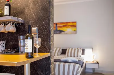 a bottle of wine on a table with a glass at ROMANTIC DELUXE SVITE wise Jacuzzi and Sauna in Athens