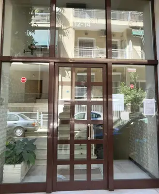 an entrance to a building with glass doors at ROMANTIC DELUXE SVITE wise Jacuzzi and Sauna in Athens