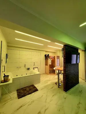 a large bathroom with a tub and a table at ROMANTIC DELUXE SVITE wise Jacuzzi and Sauna in Athens