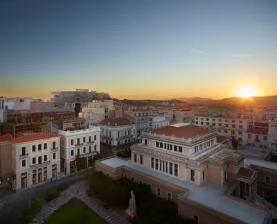 an aerial view of a city at sunset at xenodocheio Milos in Athens
