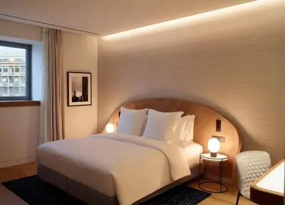 a bedroom with a large white bed and a window at xenodocheio Milos in Athens