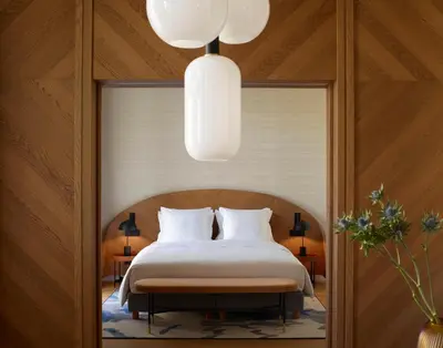 a bedroom with a bed and a chandelier at xenodocheio Milos in Athens