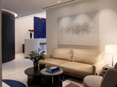 a living room with a couch and a painting at xenodocheio Milos in Athens