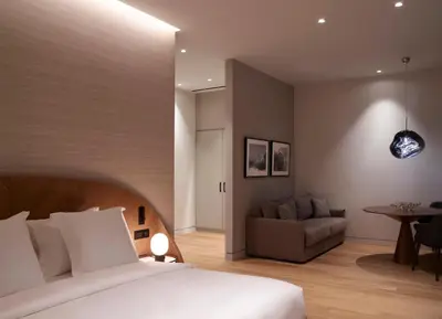 a bedroom with a bed and a couch and a table at xenodocheio Milos in Athens