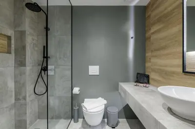 a bathroom with a sink and a toilet and a shower at Acropolis Magenta Luxury Suites in Athens