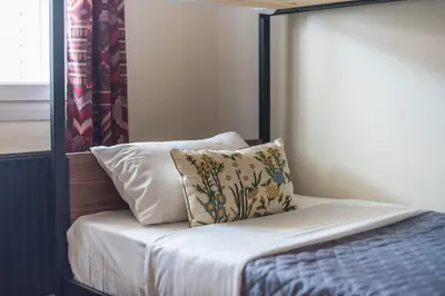 a bed with a black frame and a pillow on it at Athens Country House - Heated Jacuzzi - free bikes in Athens