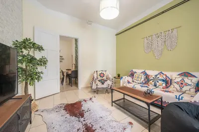 a living room with a couch and a table at Athens Country House - Heated Jacuzzi - free bikes in Athens
