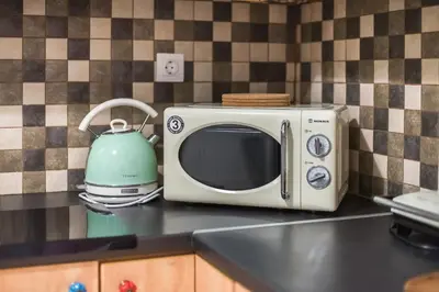 a microwave sitting on a kitchen counter with a tea kettle at Athens Country House - Heated Jacuzzi - free bikes in Athens