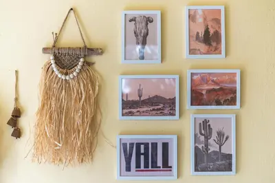 a wall with framed pictures on a wall with a necklace at Athens Country House - Heated Jacuzzi - free bikes in Athens