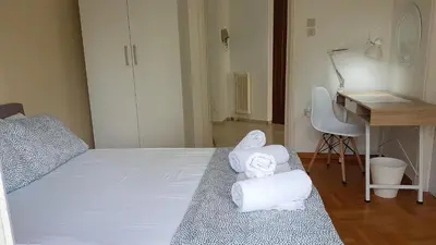 a bedroom with a bed with towels on it at Orange Apartment - Athens Center, 3 BD, 1.5 BATH in Athens