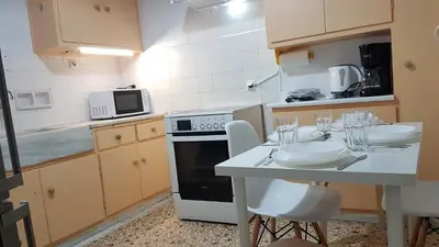 a kitchen with a table with glasses on it at Orange Apartment - Athens Center, 3 BD, 1.5 BATH in Athens