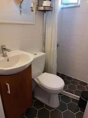 a bathroom with a white toilet and a sink at Casa Martina 2 (Spata) 10min El.Venizelos airport. in Spáta