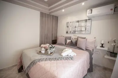 a bedroom with a large bed with a tray on it at The Ivory - Luxury & Spacious Apartment in Egaleo-Athens in Athens