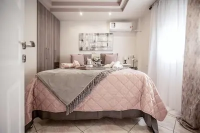 a bedroom with a bed with a pink blanket at The Ivory - Luxury & Spacious Apartment in Egaleo-Athens in Athens