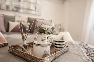 a table topped with a tray with cups and flowers at The Ivory - Luxury & Spacious Apartment in Egaleo-Athens in Athens