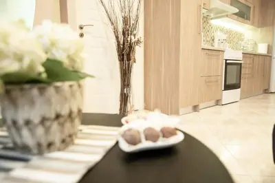 a plate of cookies on a table in a kitchen at The Ivory - Luxury & Spacious Apartment in Egaleo-Athens in Athens
