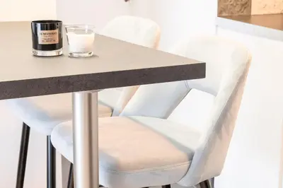 a table with white chairs and a glass of milk at Acropolis Sweet House 4 in Athens