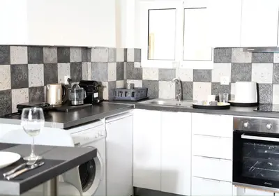 a white kitchen with a sink and a dishwasher at Acropolis Sweet House 4 in Athens