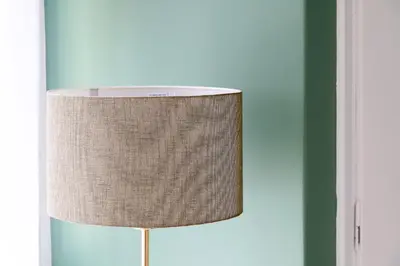 a lamp with a brown shade sitting in a room at Acropolis Sweet House 4 in Athens