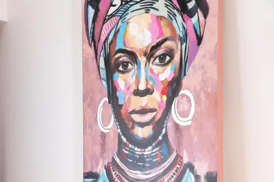 a painting of a woman wearing earrings at Acropolis Sweet House 4 in Athens