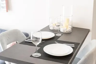 a black table with white plates and glasses on it at Acropolis Sweet House 4 in Athens