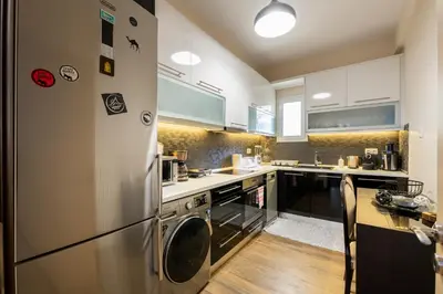a kitchen with a stainless steel refrigerator and a counter at 2bed renovated flat close to Ampelokipoi metro in Athens