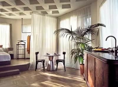 a room with a table and chairs and a bedroom at Pallineon House in Athens