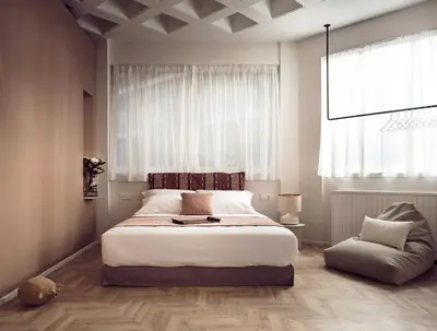 a bedroom with a large bed and a chair at Pallineon House in Athens