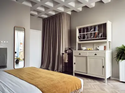 a bedroom with a large bed and a cabinet at Pallineon House in Athens