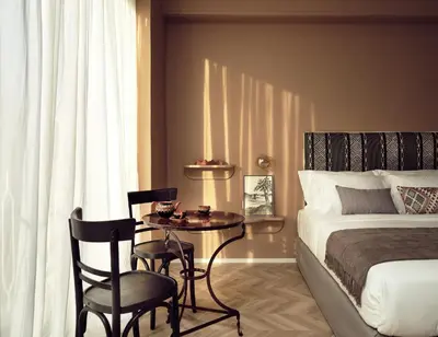 a bedroom with a bed and a table and chairs at Pallineon House in Athens