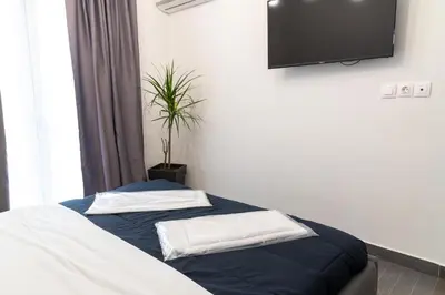 a bedroom with a bed with a tv on the wall at Monastiraki Sweet House 1 in Athens