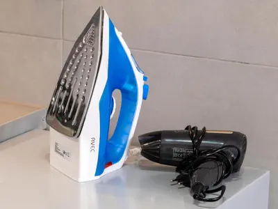 a blue and black appliance sitting on a counter next to a hairbrush at Monastiraki Sweet House 1 in Athens
