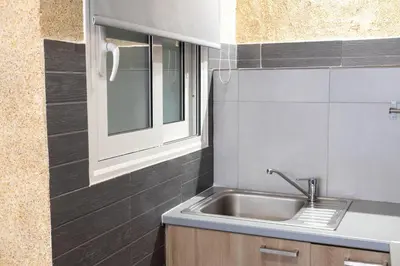 a kitchen with a sink and a window at Monastiraki Sweet House 1 in Athens