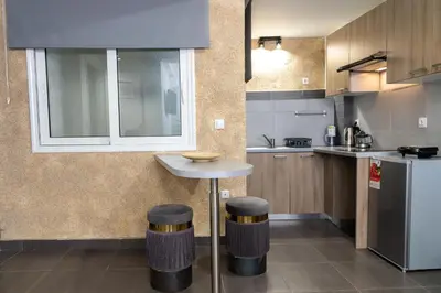 a kitchen with a table and two stools in it at Monastiraki Sweet House 1 in Athens