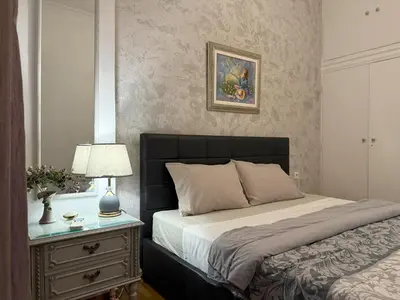 a bedroom with a bed and a table with a lamp at 2 Bedrooms Apartment Center of Athens 4 min Subway in Athens