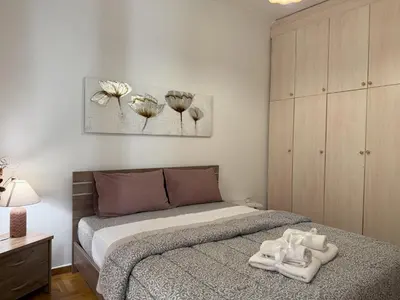 a bedroom with a bed with two towels on it at 2 Bedrooms Apartment Center of Athens 4 min Subway in Athens