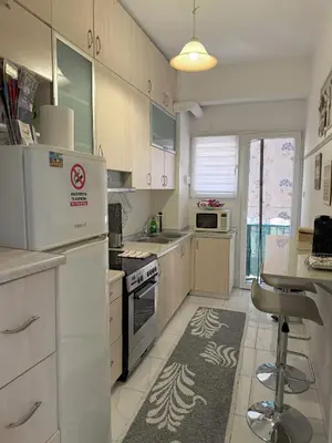 a kitchen with white appliances and a table in it at 2 Bedrooms Apartment Center of Athens 4 min Subway in Athens