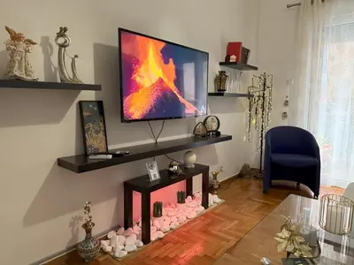 a living room with a flat screen tv on a wall at 2 Bedrooms Apartment Center of Athens 4 min Subway in Athens