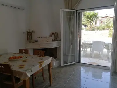 a dining room with a table and a sliding glass door at Ferienhaus Athens Marmor Garden in Kalívia Thorikoú