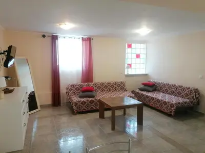 a living room with a couch and a table at Ferienhaus Athens Marmor Garden in Kalívia Thorikoú