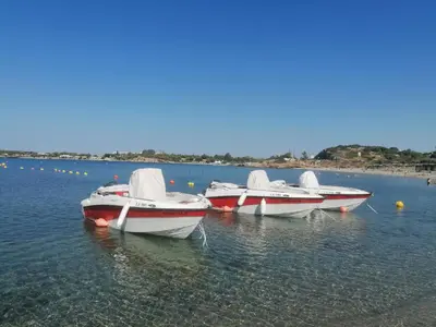 a group of boats sitting in the water at Ferienhaus Athens Marmor Garden in Kalívia Thorikoú