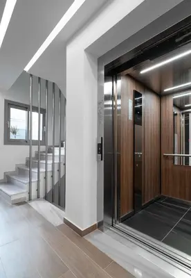 an elevator in a building with a staircase at Athens Hill Luxury Apartments in Athens