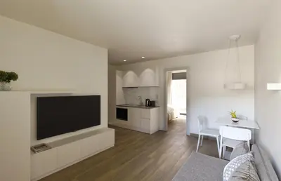 a living room with a television and a table with chairs at Athens Hill Luxury Apartments in Athens