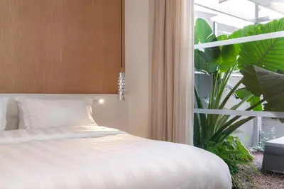 a bedroom with a bed and a large window at Athens Hill Luxury Apartments in Athens